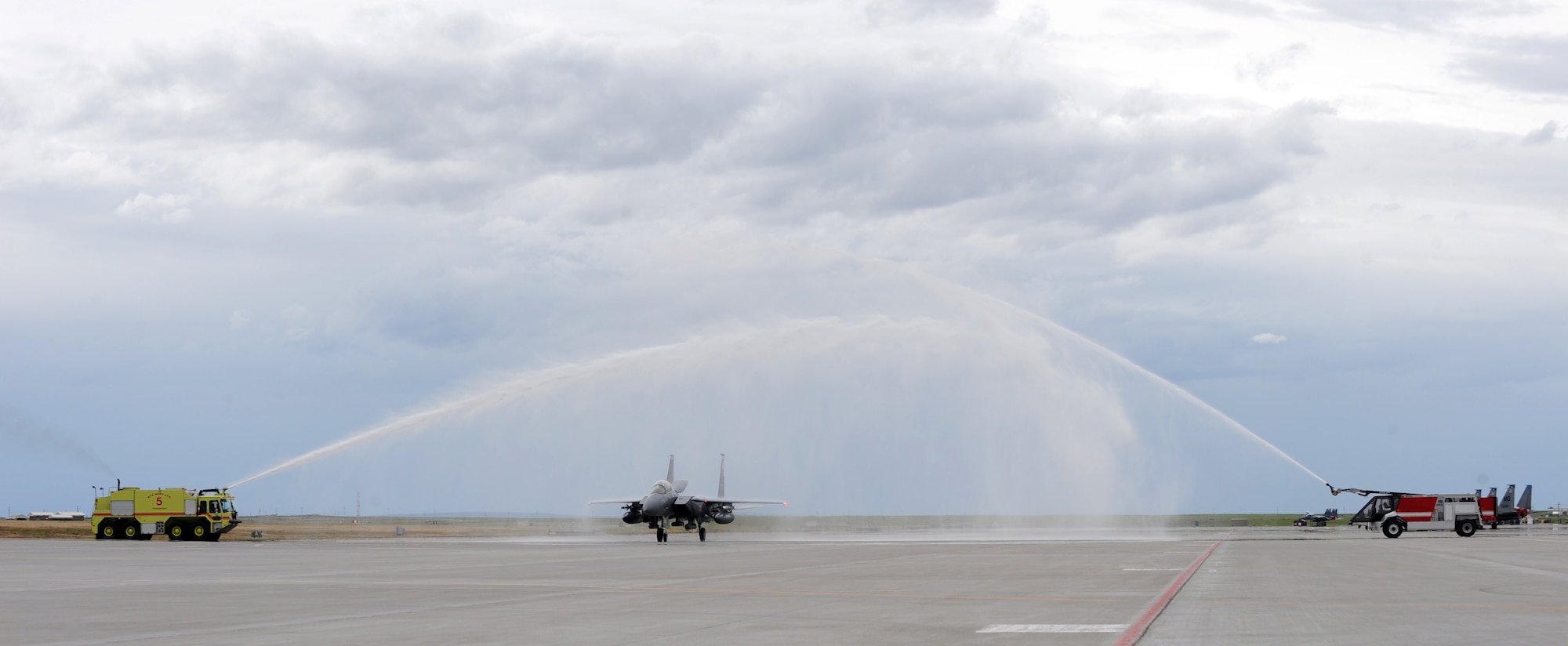 MOUNTAIN HOME AIR FORCE BASE, Idaho – Passing under an archway of water, Col. James McGovern, 366th Operations Group commander, ends his final flight in an F-15E Strike Eagle June 2. Colonel McGovern has been selected as the 607th Air and Space Operations Center commander at Osan Air Base, Korea. (U.S. Air Force photo by Airman 1st Class Debbie Lockhart)