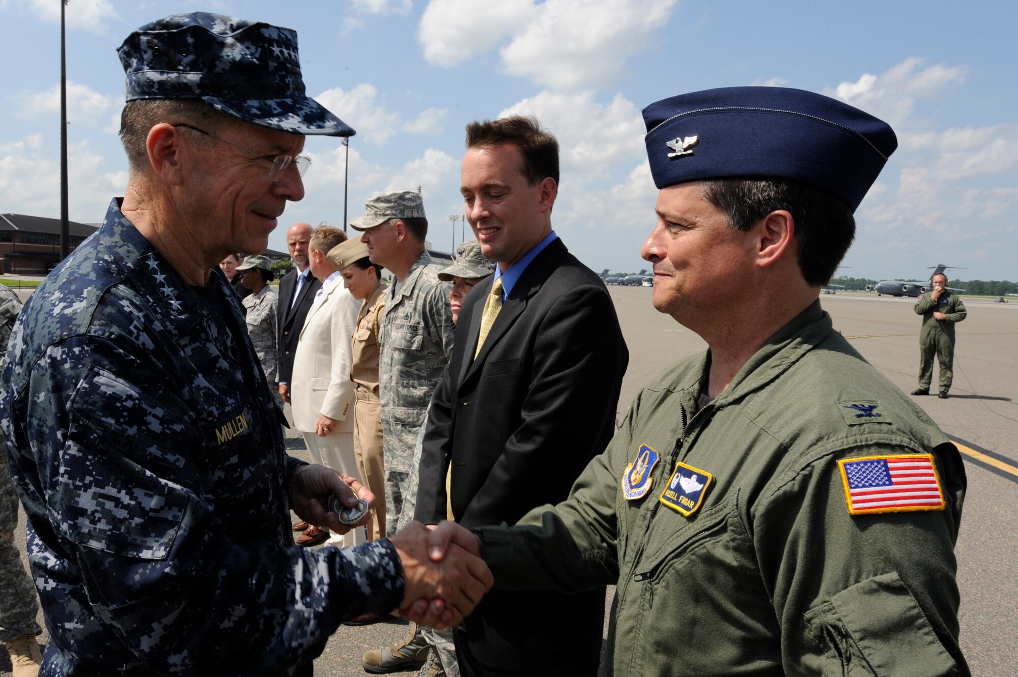 Chairman of the Joint Chiefs of Staff, U.S. Navy Adm. Mike Mullen coins Col. Russell Fingar the 315th Airlift Wing vice commander at Charleston Air Force Base, S.C., June 3, 2010. During his visit, Admiral Mullen fielded questions from officers and enlisted Airmen and addressed Department of Defense policy changes and expectations. Questions asked ranged from concerns with manning to the removal of fast food in deployed locations. (U.S. Air Force Photo/Airman 1st Class Lauren Main)