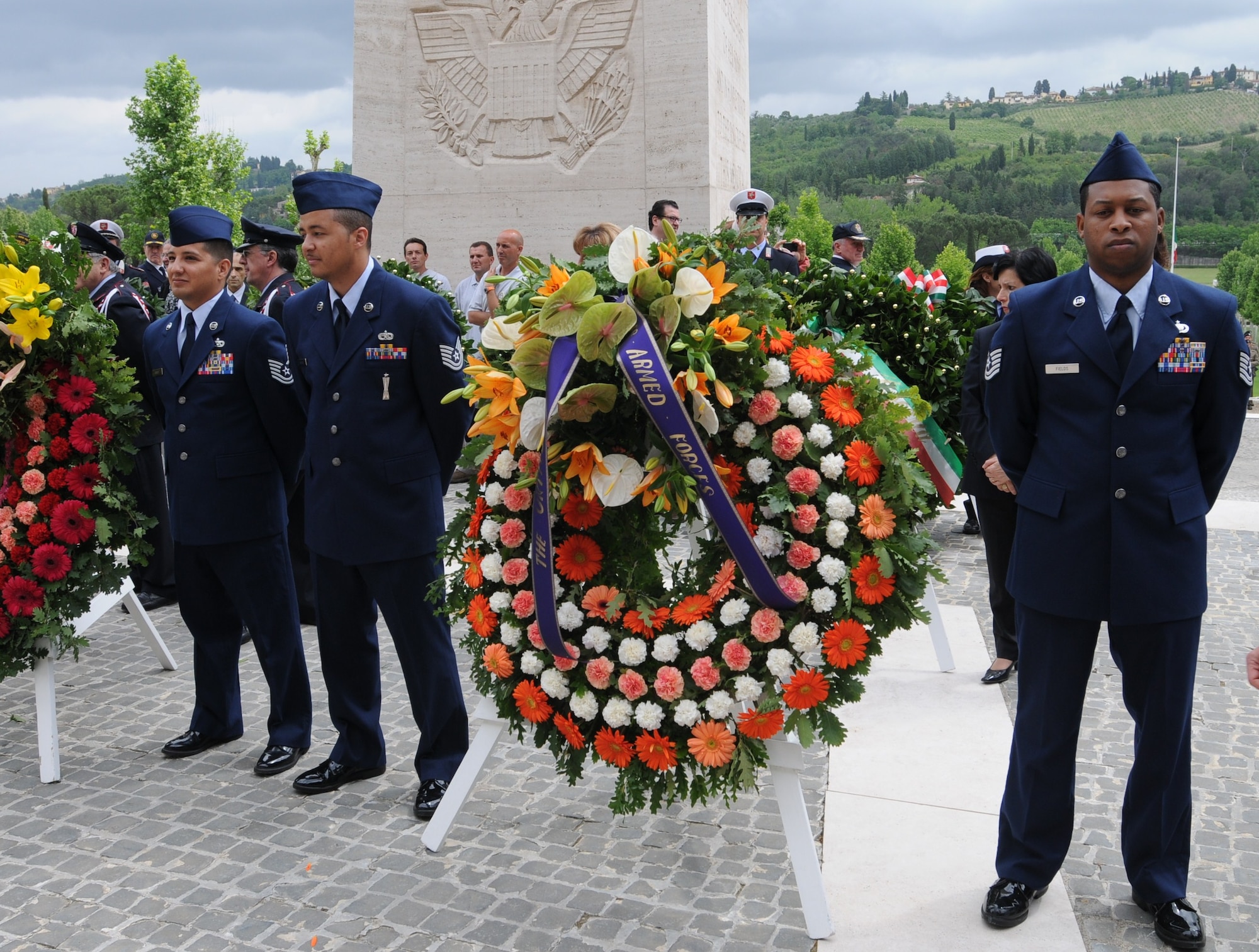 Airmen with the 731st Munitions Squadron stand beside the U.S. Armed Forces wreath prior to the beginning of the official Memorial Day ceremony at the Florence American Cemetery. More than 500 people attended the ceremony held May 31 in Florence, Italy. (U.S. Air Force photo/2nd Lt. Brian Wagner)