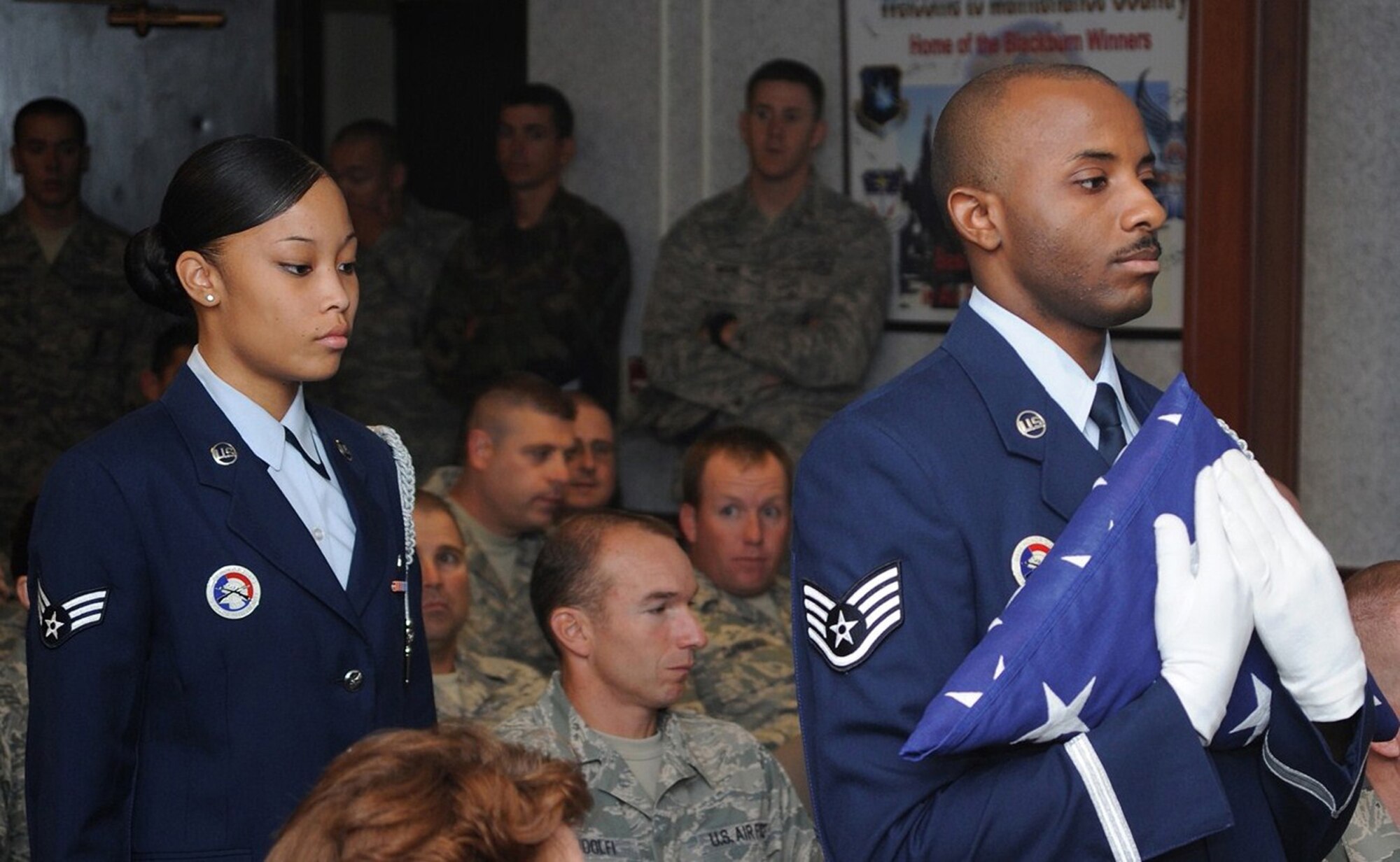 Staff Sgt. Elijah Leonard, 341st Missile Wing contractor escort, carries a ceremonial flag for a retirement detail with the base honor guard. Sergeant Leonard was recognized for completing his 100th honor guard detail May 17. (U.S. Air Force photo/Beau Wade)