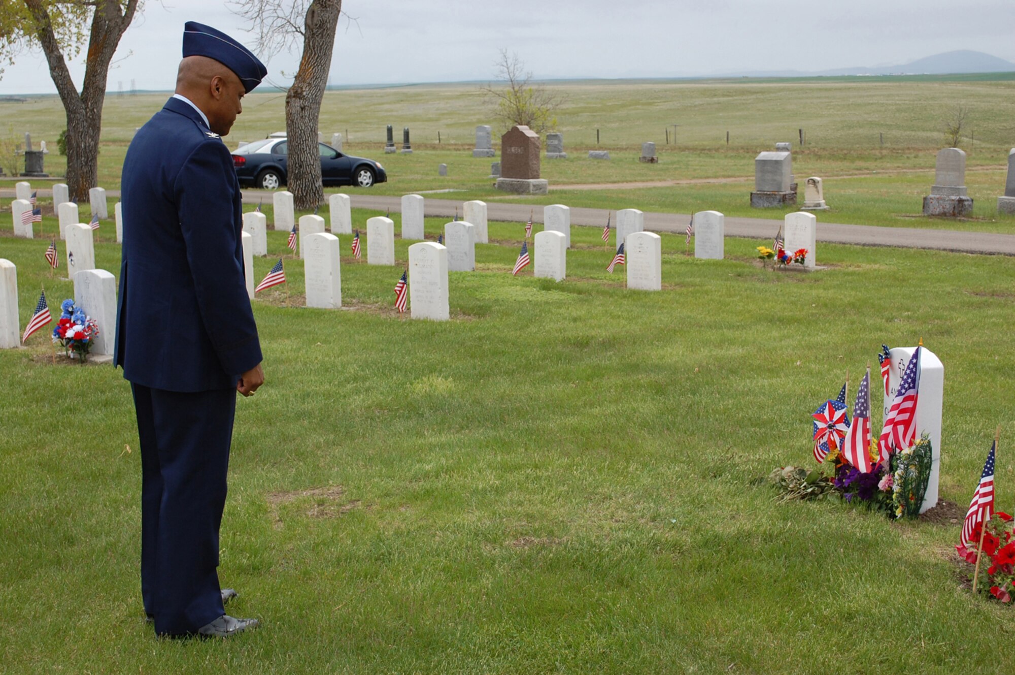 Col. Anthony Cotton, 341st Missile Wing commander, reflects at the grave site of Airman Andrew Scott Charpentier, a fallen Airman from Great Falls, Montana who passed away from a non-combat related illness incurred while assigned to Guantanamo Bay, Cuba. (U.S. Air Force Photo/Airman 1st Class Kristina Overton)