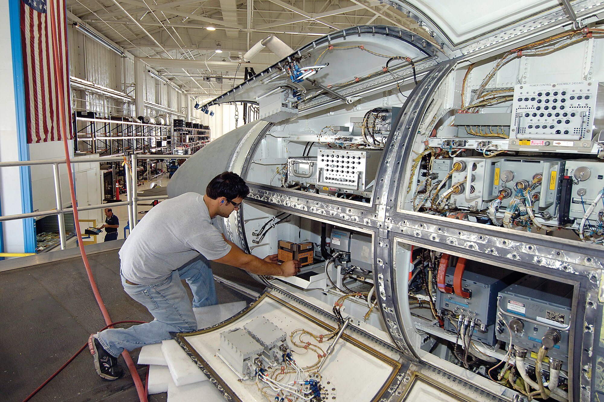 Mechanic Trevor Aldridge helps prepare a B-1 for a modification during maintenance here.  While the Air Force recognizes the first Lancer to reach 10,000 flying hours, Tinker continues to provide the bomber with upgrades and maintenance to keep it flying for 30 more years. (Air Force photo by Margo Wright)