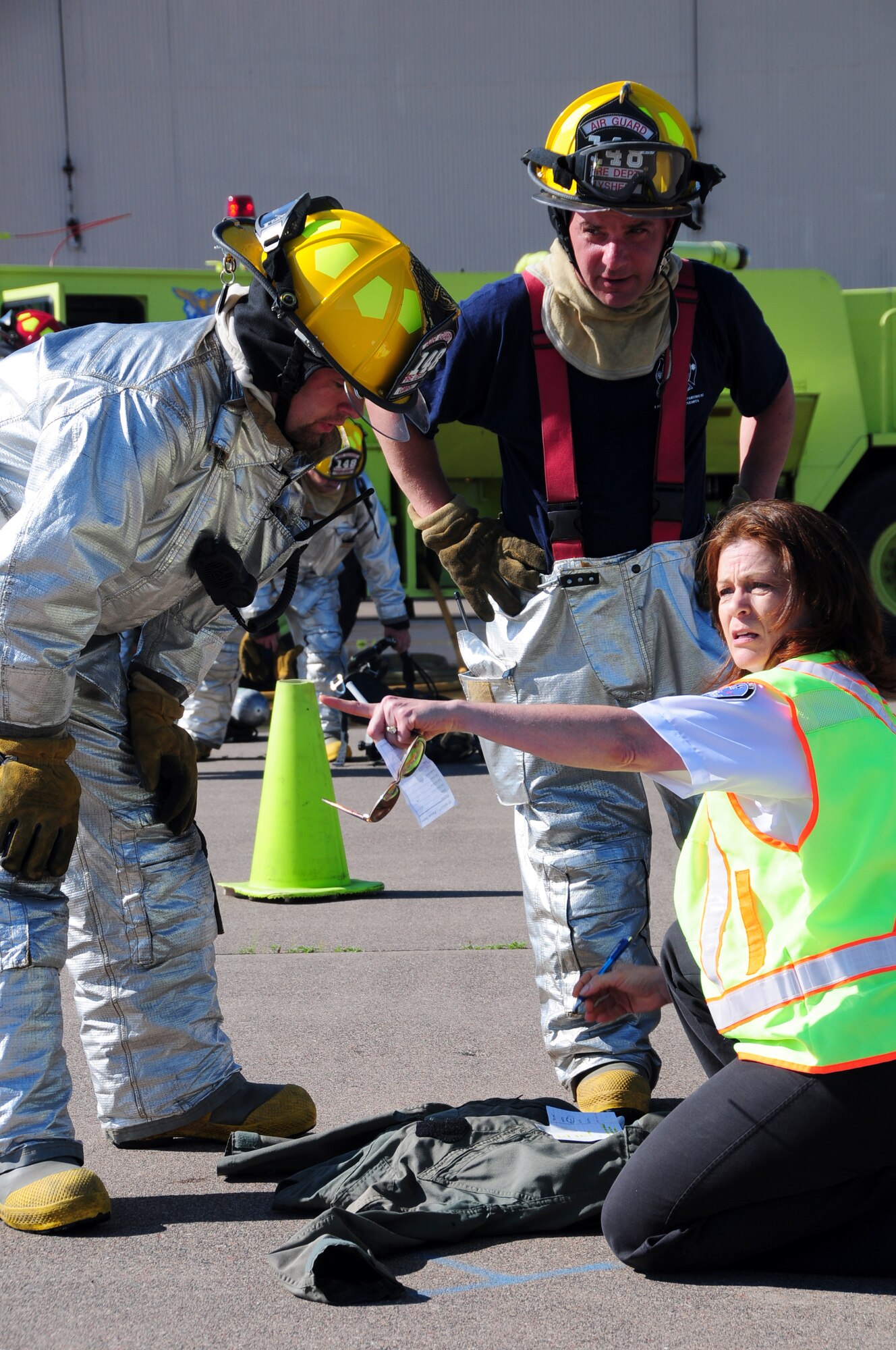 U.S. Air National Guard firefighters Tech. Sgt. Grant Gimple (left) and Senior Master Sgt. Dan Lysher, 148th Fighter Wing, asses simulated victims with an EMS from Lake County, Minn., during a Major Accident Response Exercise (MARE) of a commercial airliner crash at the Duluth International Airport, Minn., June 3, 2010. The MARE was held in conjunction with local, state and federal emergency response agencies to test and validate emergency response capabilities. (U.S. Air Force photo by Master Sgt. Jason W. Rolfe/Released)