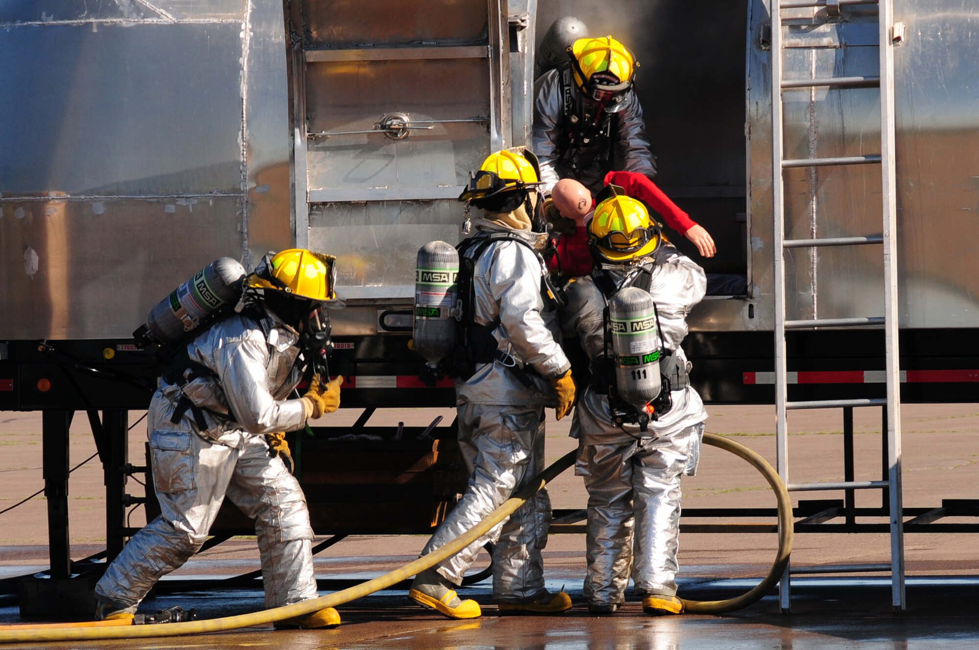 U.S. Air National Guard firefighters of the 148th Fighter Wing rescue a survivor from a simulated commercial airliner crash during a Major Accident Response Exercise (MARE) at the Duluth International Airport, Minn., June 3, 2010. The MARE was held in conjunction with local, state and federal emergency response agencies to test and validate emergency response capabilities. (U.S. Air Force photo by Master Sgt. Jason W. Rolfe/Released)