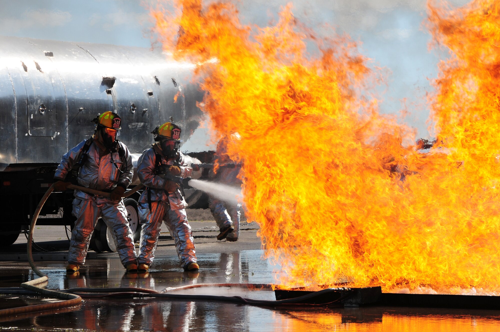U.S. Air National Guard Fire Fighter Aaron Nelson and Tech. Sgt Nick Downs, 148th Fighter Wing, fight a fire during a Major Accident Response Exercise (MARE) of a commercial airliner crash at the  Duluth International Airport, Minn., June 3, 2010. The MARE was held in conjunction with local, state and federal emergency response agencies to test and validate emergency response capabilities. (U.S. Air Force photo by Master Sgt. Jason W. Rolfe/Released)