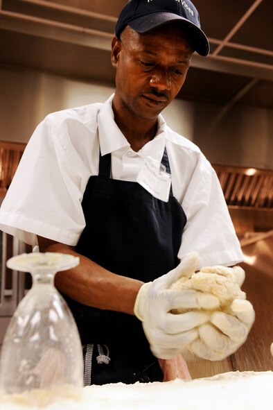 MOODY AIR FORCE BASE, Ga. -- Michael Robertson, Rice Services cook, prepares biscuits for the morning breakfast at the dining facility here May 25. Airmen and contacted personnel work together at the dining facility providing breakfast, lunch, and dinner for all Airmen on base. (U.S. Air Force photo by Airman 1st Class Joshua Green/RELEASED)