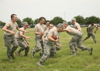 Air Force basic military trainees play football at the at the Lackland Air Force Base Amphitheater May 30. The event was part of the annual Memorial Day Jam event hosted by the Lackland First Sergeants' Council. (U.S. Air Force photo/Robbin Cresswell)