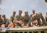 Air Force basic military trainees get their food ready at the Memorial Day Jam May 30. The event, hosted by the Lackland First Sergeants' Council, included volleyball, flag football, basketball and music. (U.S. Air Force photo/Robbin Cresswell) 
