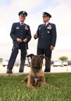 Col. William H. Mott V, 37th Training Wing commander, talks with Col. Richard M. Murphy, 12th Flying Training Wing commander, before the Air Force Basic Military Training graduation parade May 21 about his foster puppy Nnordo. (U.S. Air Force photo/Robbin Cresswell)