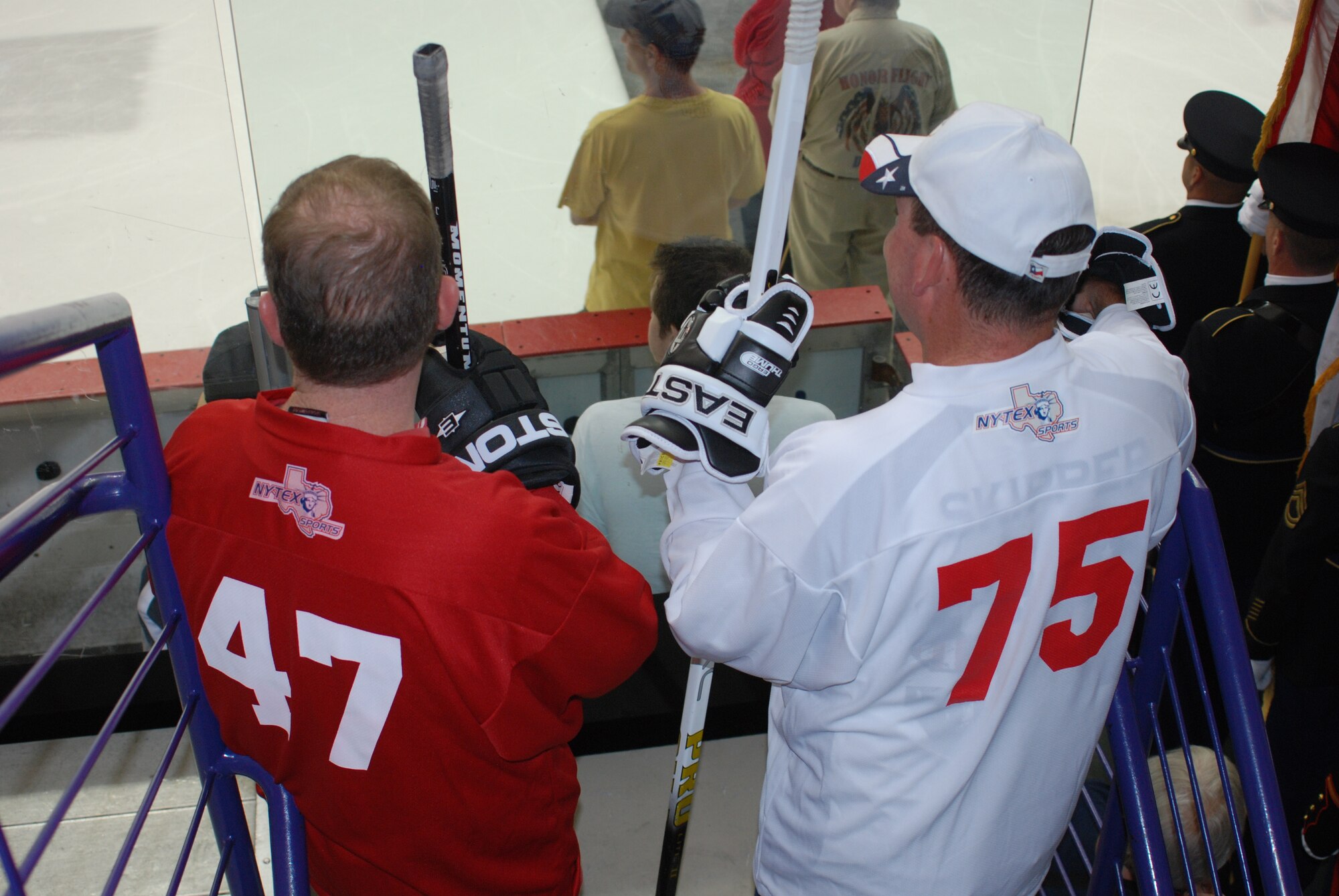 Colonel Richard Scobee (left), commander of the 301st Fighter Wing, and Navy Captain T.D. Smyers, commander of Naval Air Station Fort Worth Joint Reserve base, Texas, prepare to take the ice for a ceremonial faceoff at the 2010 Memorial Day Hockey Classic at NYTEX Sports Complex in North Richland Hills, Texas. Each of their sweaters (jerseys) have the last two numbers of the year their respective branch was established. The game pits veterens of the Army and Air Force against those of the Navy and Marines. This annual event brings hockey-playing veterans, and their fans, together to honor local veterans. (U.S. Air Force Photo/SrA Jeremy Roman)