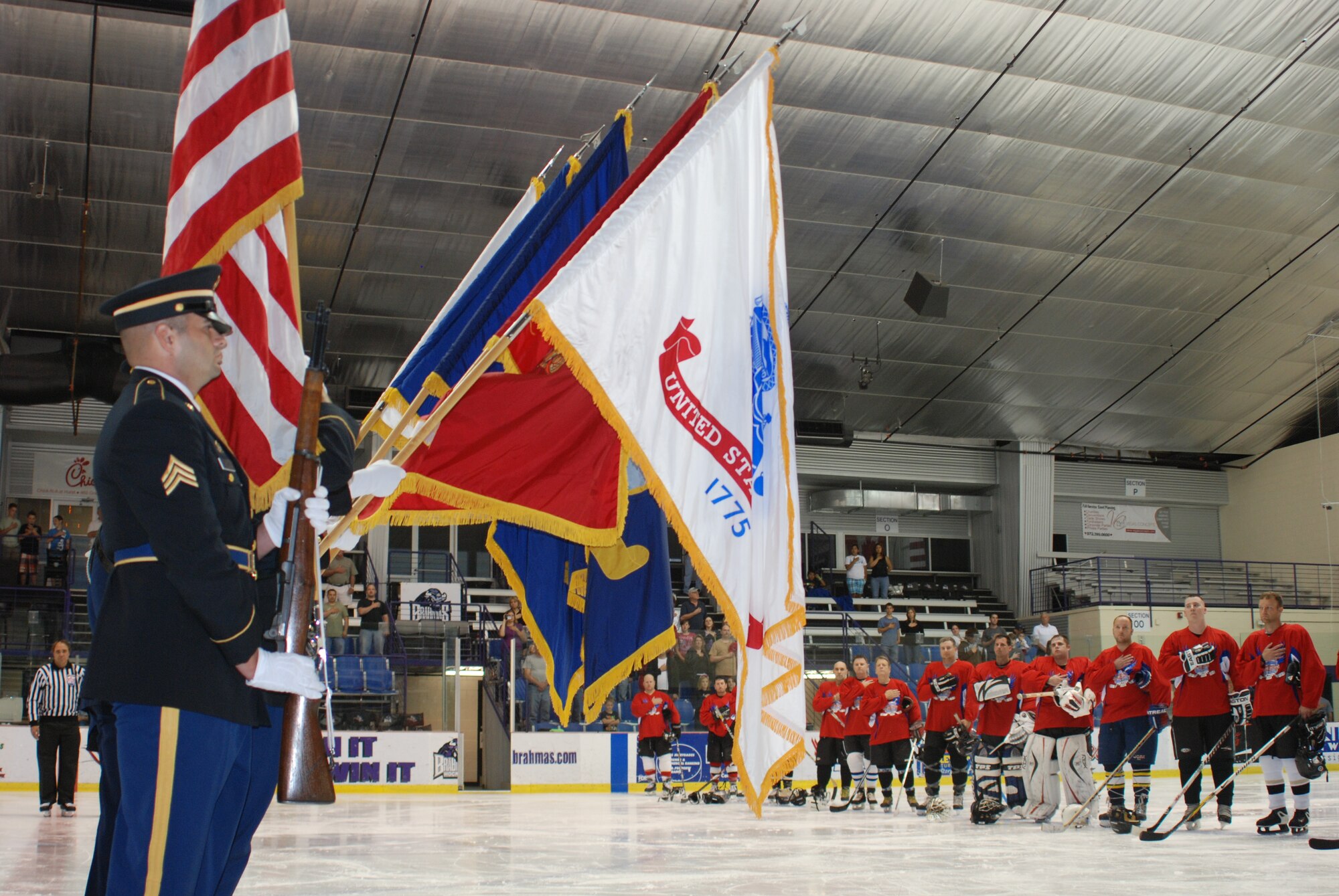 A joint services Color Guard takes the ice to present the colors before the National Anthem at the 2010 Memorial Day Hockey Classic at NYTEX Sports Complex in North Richland Hills, Texas. This annual event brings hockey-playing veterans and their fans, together to honor local veterans. (U.S. Air Force Photo/SrA Jeremy Roman)