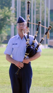 Airman Adam Tianello, 323rd Training Squadron, plays a bagpipe solo during the Air Force Basic Military Training graduation parade May 28. (U.S. Air Force photo/Alan Boedeker)