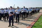 Airman Adam Tianello, 323rd Training Squadron, plays the bagpipes with the band flight during the Air Force Basic Military Training graduation parade May 28. (U.S. Air Force photo/Alan Boedeker)