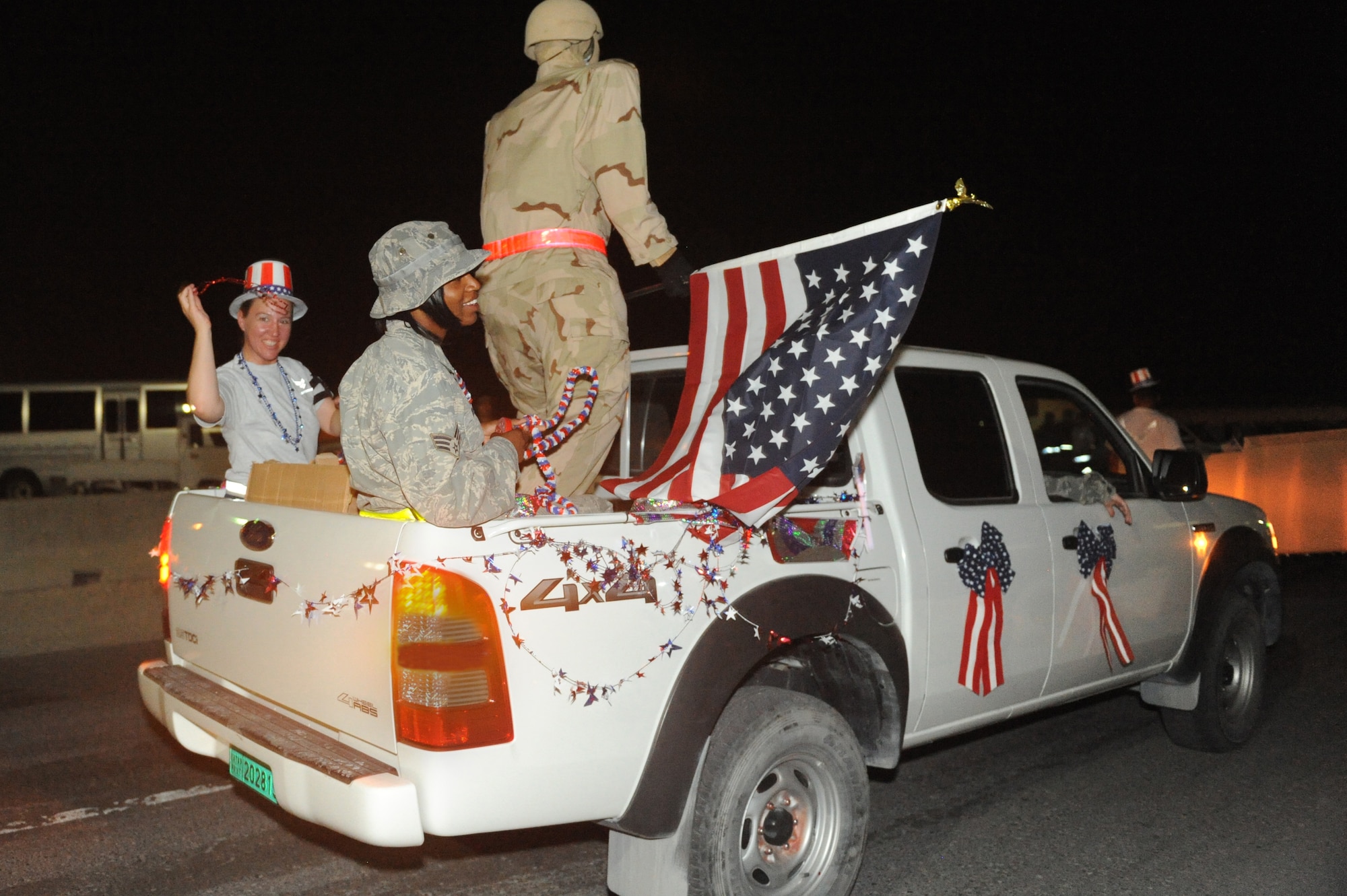 Master Sgt. Renee Munshower, 379th Expeditionary Logistics Readiness Squadron cargo movement section, and Senior Airman Latoya Neu, 379th Expeditionary Logistics Readiness Squadron receiving section, participate in a Memorial Day parade at a non-disclosed Southwest Asia location, May 31, 2010. (U.S. Air Force photo by Tech. Sgt. Michelle Larche)[RELEASED]