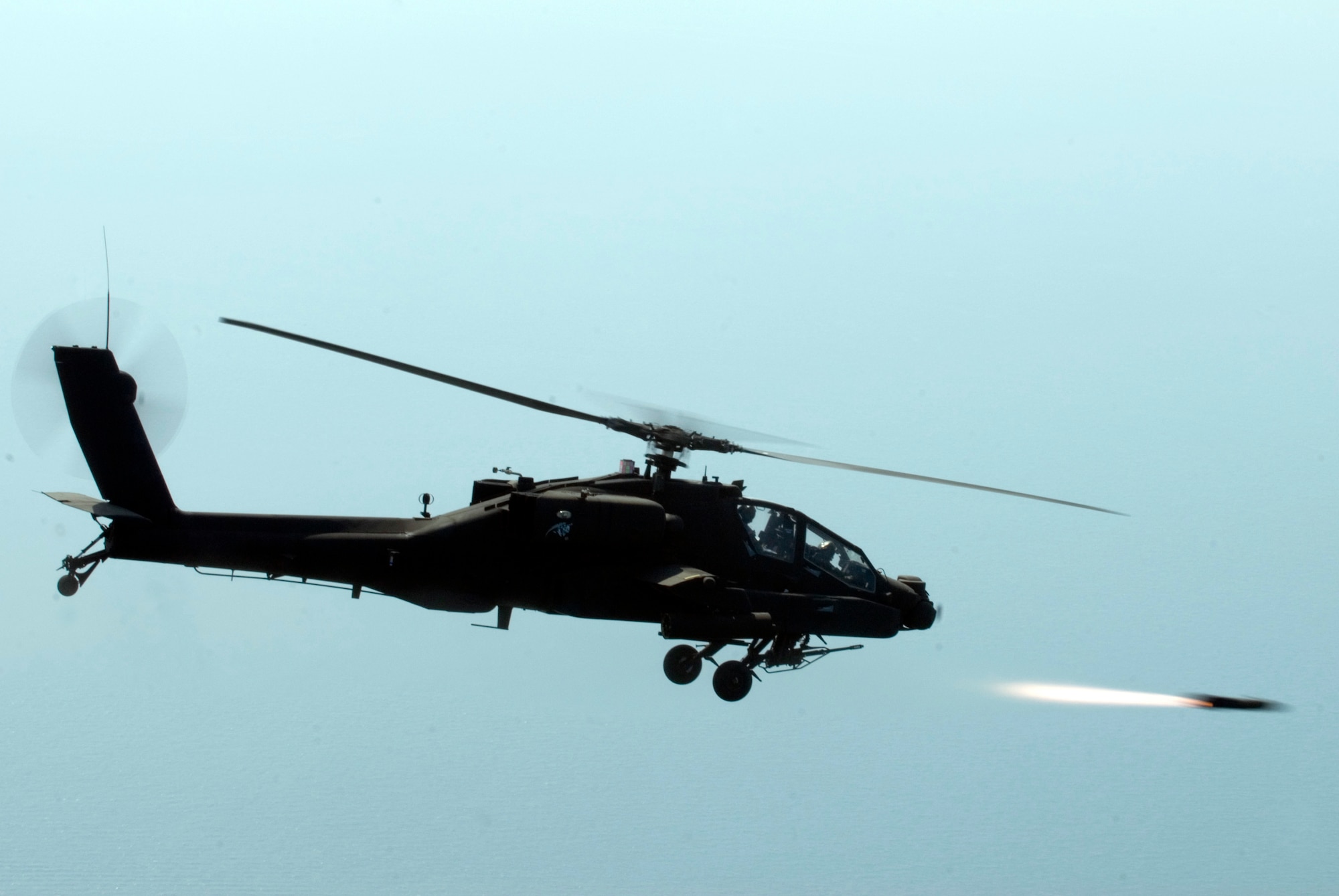 KUNSAN AIR BASE, Republic of Korea -- An AH-64 Apache helicopter assigned to the 4-2 Attack Battalion, Camp Humphreys, Republic of Korea, fires a Hellfire missile towards a target at an air-ground range  20 miles outside of Kunsan Air Base during a Joint Air Attack combat readiness training session, June 3.  Several Apache crews fired Hellfire missiles, 30mm rounds  and rockets during the four day training mission. Overall, a total of 155 Hellfire missiles, 152 HE 2.75 inch rockets, 50 illumination 2.75 inch rockets, 1,560 rounds of 30 mm HE rounds  were fired by the 26 Apache crews involved in the training. "The exercise provided valuable joint air attack team training and enhanced combat readiness," said Maj. Kyle Armstrong, 8th Operational Support Squadron assistant director of operations. (U.S. Air Force photo/Staff Sgt. Jonathan Pomeroy)