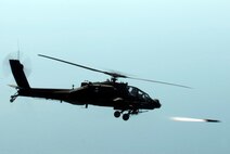 KUNSAN AIR BASE, Republic of Korea -- An AH-64 Apache helicopter assigned to the 4-2 Attack Battalion, Camp Humphreys, Republic of Korea, fires a Hellfire missile towards a target at an air-ground range  20 miles outside of Kunsan Air Base during a Joint Air Attack combat readiness training session, June 3.  Several Apache crews fired Hellfire missiles, 30mm rounds  and rockets during the four day training mission. Overall, a total of 155 Hellfire missiles, 152 HE 2.75 inch rockets, 50 illumination 2.75 inch rockets, 1,560 rounds of 30 mm HE rounds  were fired by the 26 Apache crews involved in the training. "The exercise provided valuable joint air attack team training and enhanced combat readiness," said Maj. Kyle Armstrong, 8th Operational Support Squadron assistant director of operations. (U.S. Air Force photo/Staff Sgt. Jonathan Pomeroy)