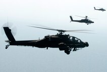 KUNSAN AIR BASE, Republic of Korea -- Three AH-64 Apache helicopter assigned to the 4-2 Attack Battalion, Camp Humphreys, Republic of Korea, sets to fire Hellfire missiles toward a target at an air-ground range  20 miles outside of Kunsan Air Base during a Joint Air Attack combat readiness training session, June 3.  Several Apache crews fired Hellfire missiles, 30mm rounds  and rockets during the four day training mission. Overall, a total of 155 Hellfire missiles, 152 HE 2.75 inch rockets, 50 illumination 2.75 inch rockets, 1,560 rounds of 30 mm HE rounds  were fired by the 26 Apache crews involved in the training. "The exercise provided valuable joint air attack team training and enhanced combat readiness," said Maj. Kyle Armstrong, 8th Operations Support Squadron assistant director of operations. (U.S. Air Force photo/Staff Sgt. Jonathan Pomeroy)