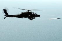 KUNSAN AIR BASE, Republic of Korea -- An AH-64 Apache helicopter assigned to the 4-2 Attack Battalion, Camp Humphreys, Republic of Korea, fires a Hellfire missile towards a target at an air-ground range,  20 miles outside of Kunsan Air Base, during a Joint Air Attack combat readiness training session, June 3.  Several Apache crews fired Hellfire missiles, 30mm rounds  and rockets during the four day training mission. Overall, a total of 155 Hellfire missiles, 152 HE 2.75 inch rockets, 50 illumination 2.75 inch rockets, 1,560 rounds of 30 mm HE rounds  were fired by the 26 Apache crews involved in the training. "The exercise provided valuable joint air attack team training and enhanced combat readiness," said Maj. Kyle Armstrong, 8th Operations Support Squadron assistant director of operations. (U.S. Air Force photo/Staff Sgt. Jonathan Pomeroy)