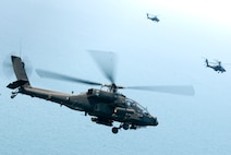 KUNSAN AIR BASE, Republic of Korea -- Three AH-64 Apache helicopter assigned to the 4-2 Attack Battalion, Camp Humphreys, Republic of Korea, get ready to fire Hellfire missiles towards a target at an air-ground range,  20 miles outside of Kunsan Air Base, during a Joint Air Attack combat readiness training session, June 3.  Several Apache crews fired Hellfire missiles, 30mm rounds  and rockets during the four day training mission. Overall, a total of 155 Hellfire missiles, 152 HE 2.75 inch rockets, 50 illumination 2.75 inch rockets, 1,560 rounds of 30 mm HE rounds  were fired by the 26 Apache crews involved in the training. "The exercise provided valuable joint air attack team training and enhanced combat readiness," said Maj. Kyle Armstrong, 8th Operations Support Squadron assistant director of operations. (U.S. Air Force photo/Staff Sgt. Jonathan Pomeroy)