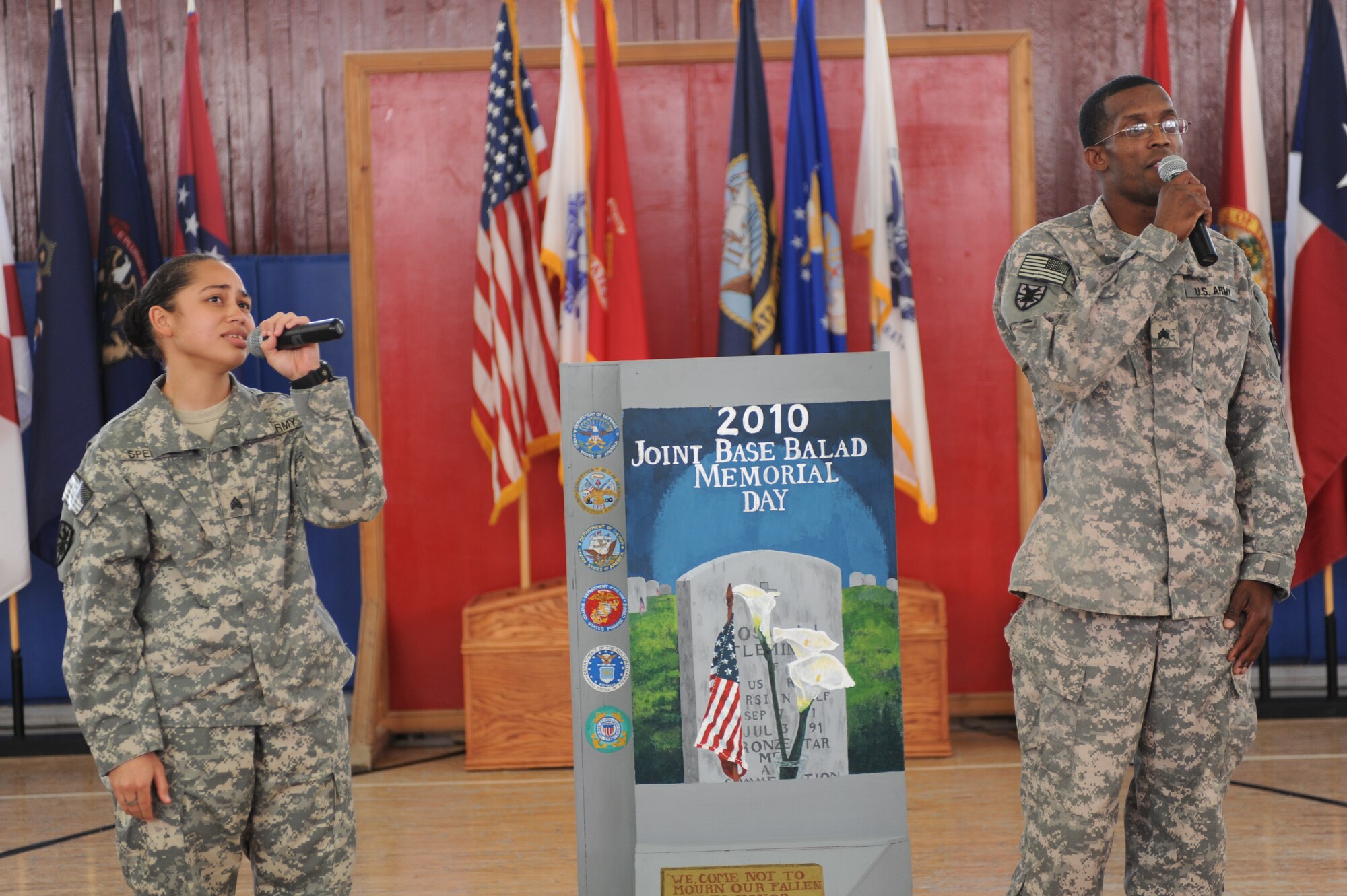 Sergeant’s Denice Spencer and Jamaal Wesley, 159th Seaport Operations Company members, sing a rendition of Amazing Grace, during the Memorial Day ceremony at Joint Base Balad, Iraq, May 31, 2010. The ceremony consisted of the unveiling of a mini T-wall memorial, musical performances, reading of the proclamation from President Obama, and guest speakers representing the Air Force, Navy, Coast Guard, and Army sharing stories of fellow personnel that made the ultimate sacrifice for their nation.  (U.S. Air Force photo/Master Sgt. Linda C. Miller)