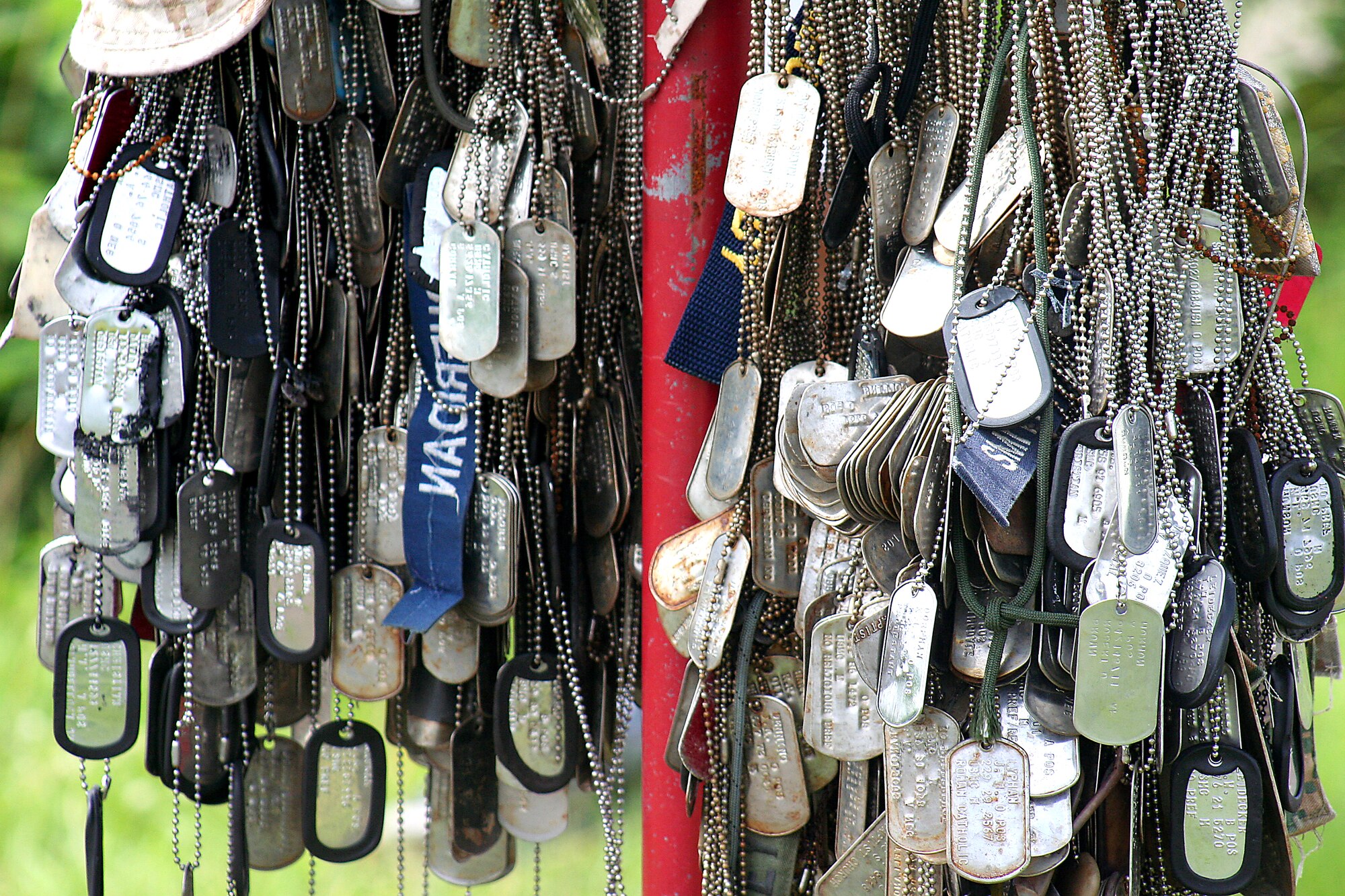 Many dog tags hang on a post left by visitors who toured the island of Iwo Jima, May 28. Mr. D’Angina, 353d Special Operations Group historian and Dr. Ian Spurgeon, 18th Wing historian, gave the Airmen and Marines a better perspective of the historical conflict in the Pacific theater as they toured through the caves, tunnels, the airfield, and the most prominent feature of the island, Mount Suribachi.  (Courtesy photo)    