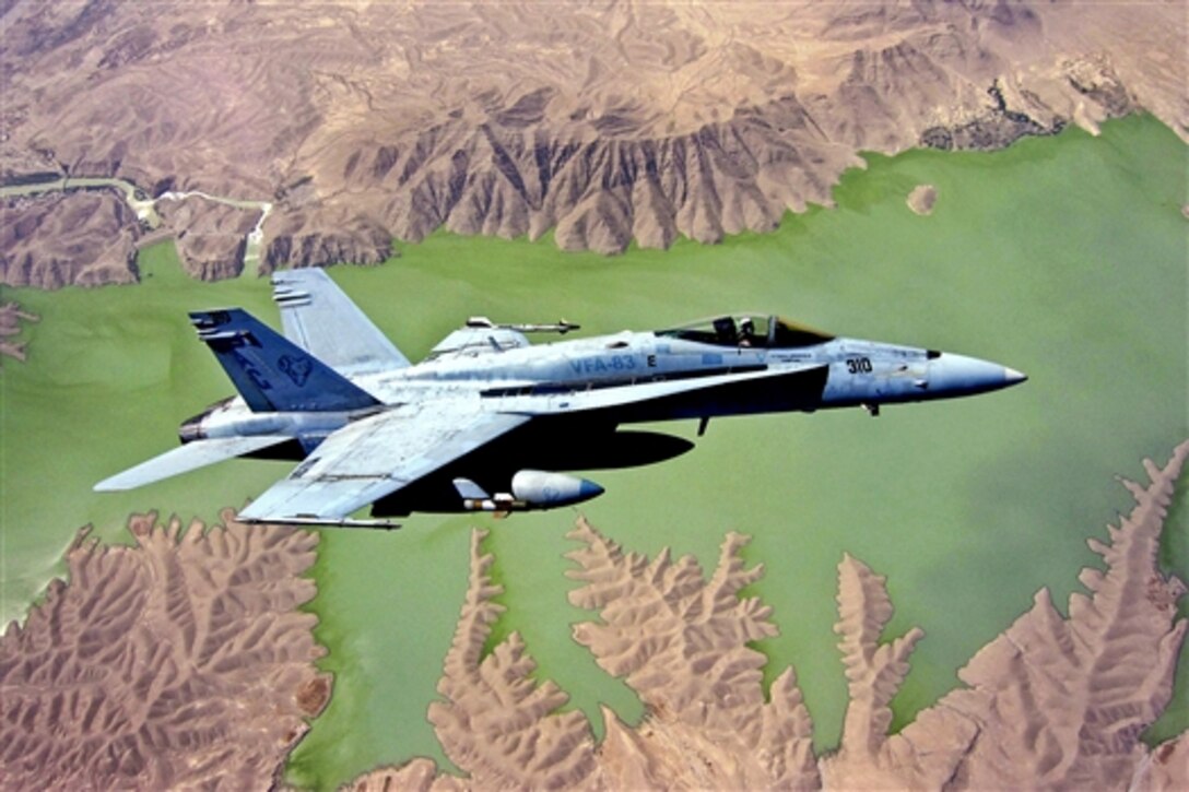 An F/A-18E Super Hornet flies over the Kajaki Dam reservoir in Afghanistan, May 20, 2010. The aircraft is part of Strike Fighter Squadron 83. The squadron is assigned to the USS Dwight D. Eisenhower, which is at sea in the Persian Gulf and Middle East regions.