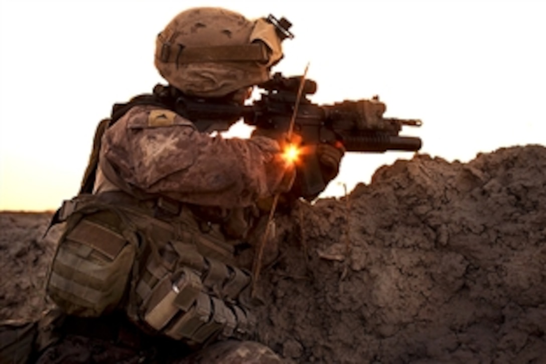 U.S. Marine Corps Lance Cpl. Naoto Nakamura scans a village on the other side of a canal near Parghee Bagat in southern Afghanistan, May 31, 2010. Nakamura is assigned to Charlie Company, 1st Light Armored Reconnaissance Battalion. The Marines have been patrolling the villages and open terrain near Parghee Bagat to identify trends in the day-to-day lives of local Afghans.