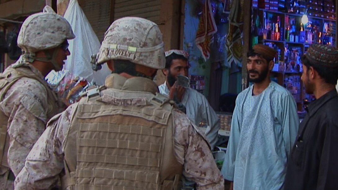 Marines with 9th Engineer Support Battalion, 1st Marine Logistics Group (Forward), speak with Afghan locals through an interpreter about a road-repairing project in Marjah, Afghanistan, June 4. The improvement of 'Route Marcie' is one of many route-repairing missions 9th ESB will complete during their deployment.