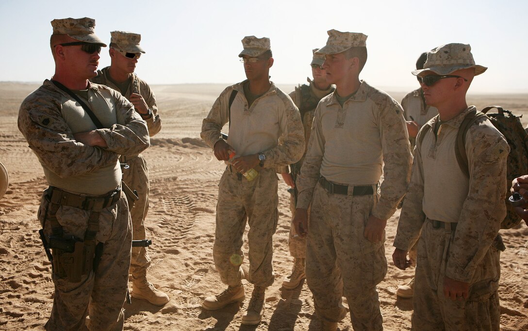 Gunnery Sgt. Jeremy Gohl (left), team leader, Personal Security Detail, Combat Logistics Battalion 6, briefs his team on what tasks that must be completed before escorting the battalion commander and sergeant major to a patrol base in Buji Pass the following day June 6. The 12-man team is charged with providing the battalion commander, Lt. Col. Mike Lepson, a safe and efficient means of travel within the unit’s battle space.