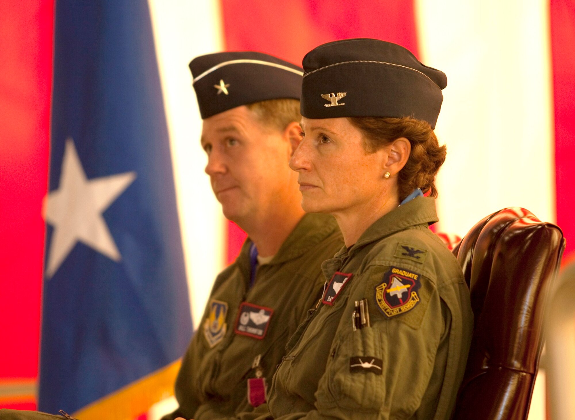 Brig. Gen. William Thornton and Col. Dawn Dunlop listen to Air Force Flight Test Center commander, Maj. Gen. David Eichhorn speak.  Colonel Dunlop assumed command of the 412th Test Wing from General Thornton June 4.  General Thornton moves on to Air Froce Materiel Command headquarters at Wright-Patterson AFB, Ohio. (Air Force photo by Greg L. Davis)