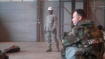 Lt. Col. Charles Combs, 916th Maintenance Group commander, listens to a cadre instructor about the properly wear of the chemical ensemble. More than 600 active duty and Reserve Airmen from the 916th and 440th Airlift Wing participated in Operation Readiness Safegaurd at Volk Field, Wisconsin in early June. (USAF photo by Maj. Shannon Mann, 916ARW/PA)