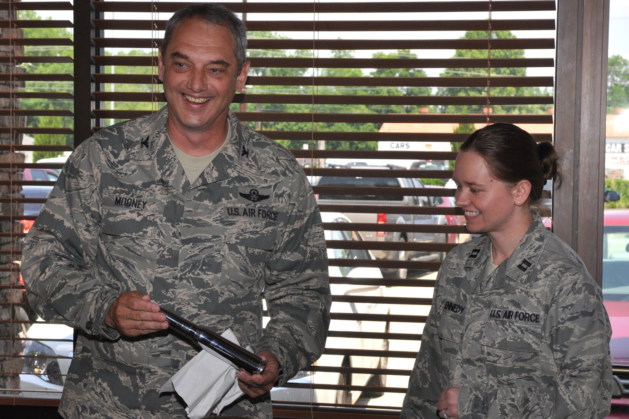 Col. John J. Mooney III, commander, 917th Wing, Barksdale Air Force Base, La., presents an engraved chrome-plated 30mm shell from an A-10 Thunderbolt II as a parting gift to Capt. Stephanie Kennedy, executive officer, 917th Wing, during her farewell luncheon at a local eatery in Bossier City, La., May 27, 2010. Approximately 40 co-workers and friends gathered to say goodbye to Capt. Kennedy who is leaving Barksdale after three years of dedicated service. She will move forward with her career at Whiteman Air Force Base, Mo.  Capt. Marlette Loughmiller will act as the interim executive officer until a replacement can be hired. (U.S. Air Force photo/Tech. Sgt. Jeff Walston)    