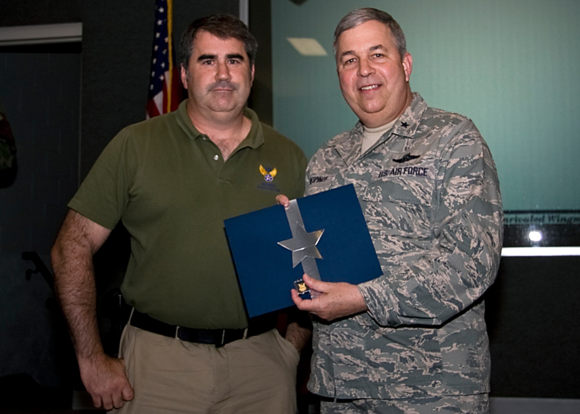 GRISSOM AIR RESERVE BASE, Ind. -- Dan Deangulo, a base emergency manager with the 434th Civil Engineer Squadron, receives a pin and certificate from Brig. Gen. Dean Despinoy recognizing his 30 years in civil service.  (U.S. Air Force photo/Tech. Sgt. Mark R. W. Orders-Woempner)