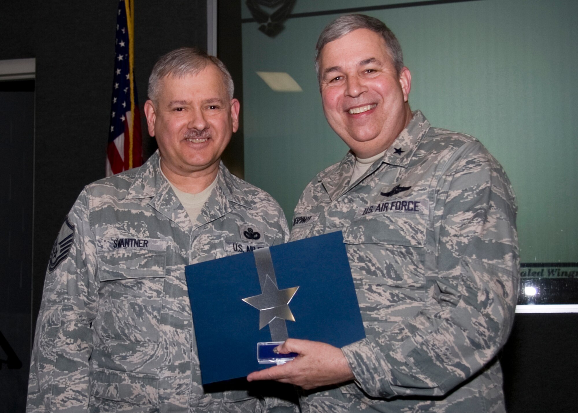 GRISSOM AIR RESERVE BASE, Ind. -- Master Sgt. Wayne Svantner, a security forces training manager with the 434th Security Forces Squadron, receives a pin and certificate from Brig. Gen. Dean Despinoy recognizing his 20 years in civil service.  (U.S. Air Force photo/Tech. Sgt. Mark R. W. Orders-Woempner)