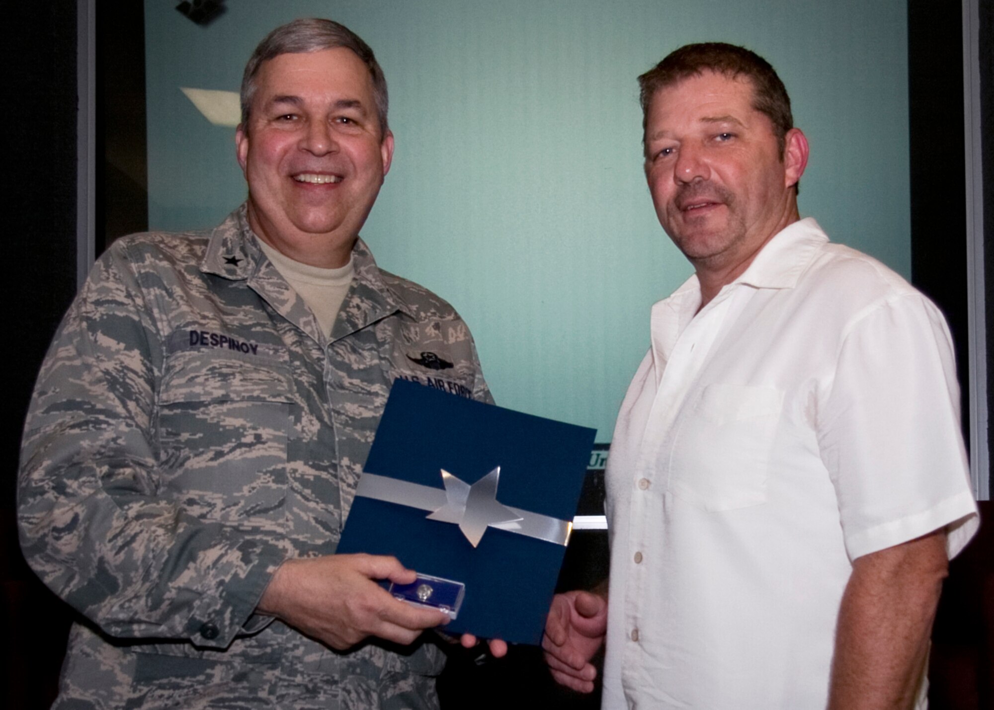 GRISSOM AIR RESERVE BASE, Ind. -- Craig Littrell, and air traffic control supervisor with the 434th Operations Support Squadron, poses for a photo with Brig. Gen. Dean Despinoy after being recognized for 20 years of federal service during a recent civilian commander's call here.  (U.S. Air Force photo/Tech. Sgt. Mark R. W. Orders-Woempner)