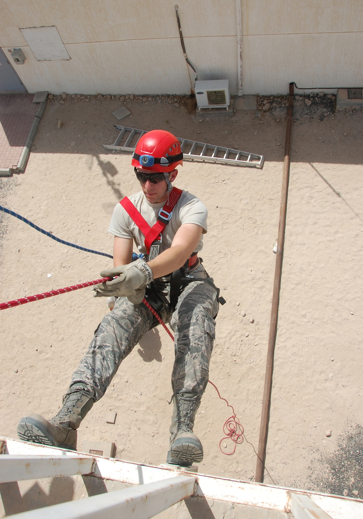 U.S. Air Force cadet Jeff Larkin, a Texas native, descends from a tower platform using high angle rescue techniques taught by 386th Expeditionary Civil Engineer Squadron firefighters here June 5, 2010 at an air base in Southwest Asia. Twenty cadets are visiting the 386th Air Expeditionary Wing this month to experience military life downrange. (U.S. Air Force photo by Staff Sgt. Lakisha A. Croley/Released)