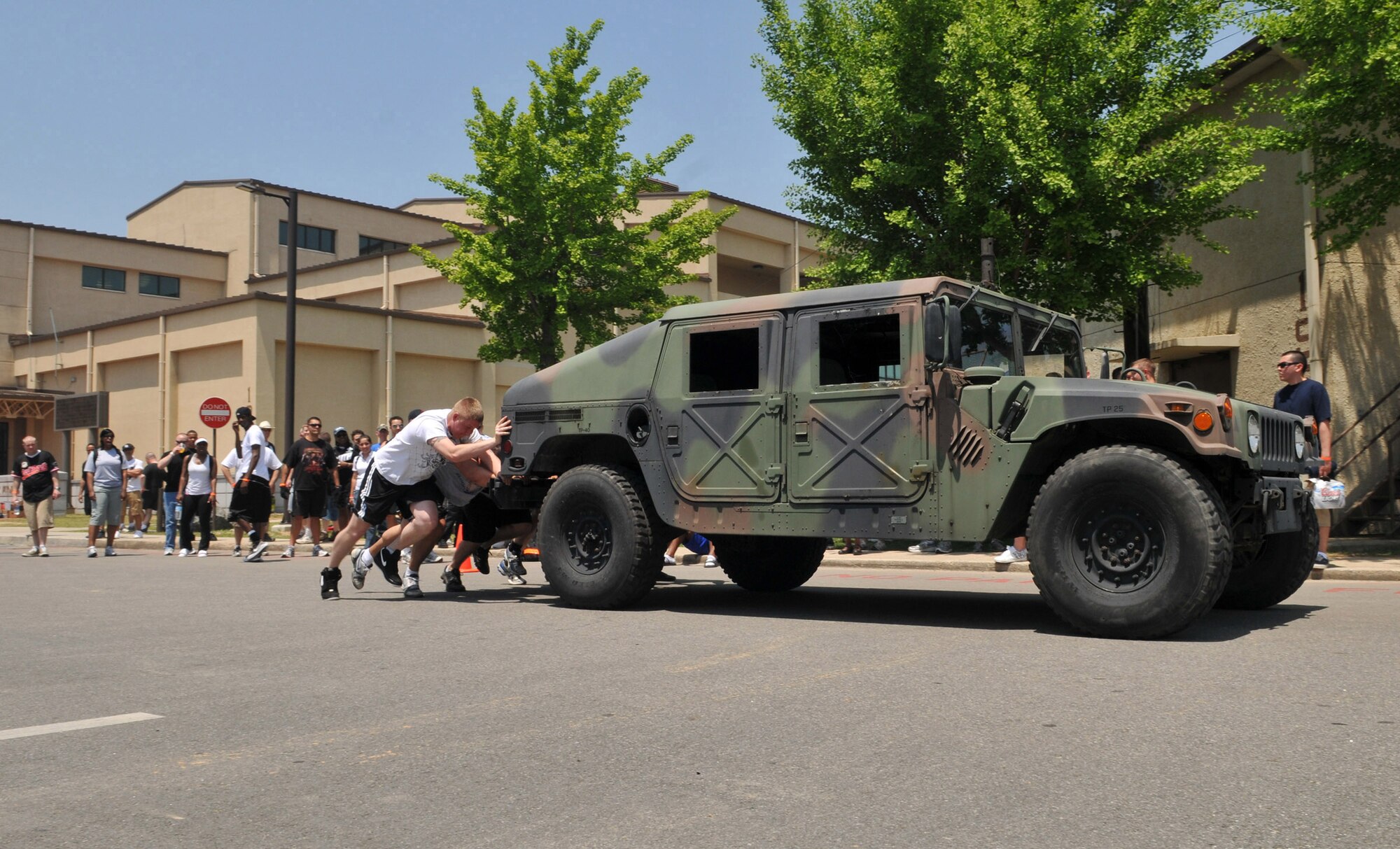 Staff Sgt. Angel Munoz, Tech. Sgt. Parrish Johnson, Airman 1st Class Zachary Moore, Airman 1st Class Elijah Toth and Airman 1st Class John Ozborne, 8th Communications Squadron, push their way to a win during a Humvee push competition May 21 at Kunsan Air Base, Republic of Korea. The event was one of many junior Wolf Pack Airmen participated in for the 8th Fighter Wing Junior Enlisted Appreciation Day. The challenge was for the teams to pus the Humvee to a specified distance within the quickest time. The Top III Association sponsored the day of music, sports, food and fun as a way to thank junior enlisted members for the hard work they do every day to accomplish the wing's mission. (U.S. Air Force photo/Capt. Shannon Collins)