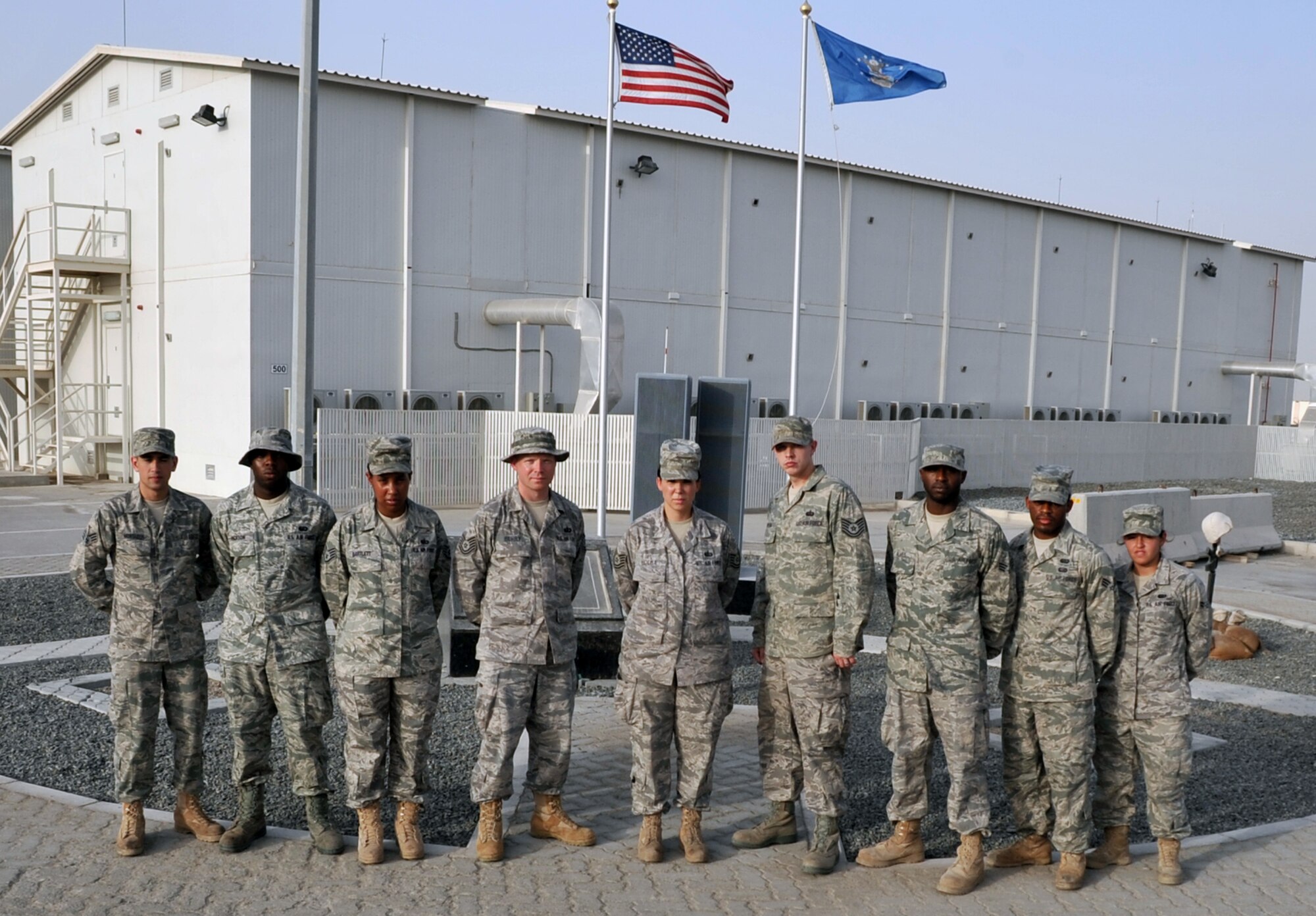 A nine-person team from the New Jersey Air National Guard's 108th Force Support Squadron, 108th Air Refueling Wing, at Joint Base McGuire-Dix-Lakehurst, N.J., are deployed supporting operations Iraqi Freedom, Enduring Freedom and the Combined Joint Task Force-Horn of Africa for the 380th Air Expeditionary Wing at a non-disclosed Base in Southwest Asia. Their deployed unit is the 380th Expeditionary Force Support Squadron and they are pictured here on June 1, 2010. The team includes, from left, Senior Airman Abdul Montaser, Airman 1st Class Andre Jackson, Staff Sgt. Heather Bartlett, Tech. Sgt. Jeremy Berry, Tech. Sgt. Lauren Holba, Tech. Sgt. Taylor Holba, Senior Airman Darnell Holmes, Senior Airman Levar Kinard, and Airman 1st Class Patricia Arias. (U.S. Air Force Photo/Master Sgt. Scott T. Sturkol/Released)