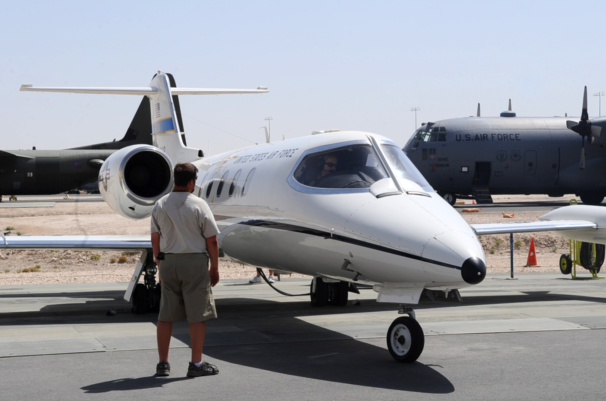 Mark Hilton, air frame and power plant technician contractor, inspects a C-21 aircraft engine as it prepares for flight at a non-disclosed Southwest Asia location May 28, 2010. (U.S. Air Force photo by Senior Airman Kasey Zickmund)[RELEASED]