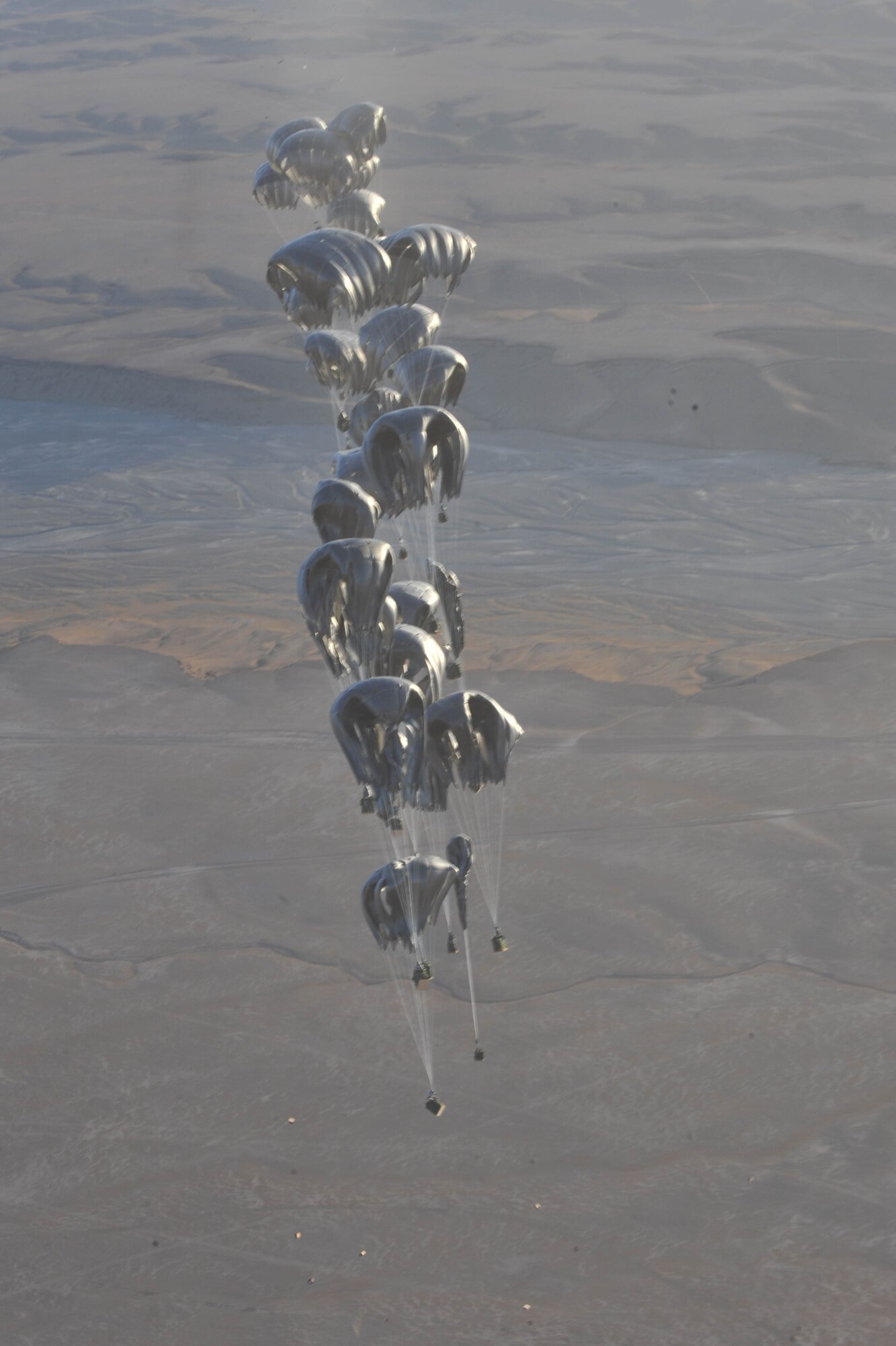 Container delivery system bundles float to the ground during an airdrop mission over Afghanistan May 27, 2010.  The bundles contained food, water and fuel for the Combined Joint Special Operations Task Force.  (U.S. Air Force photo/Staff Sgt. Quinton Russ/released)