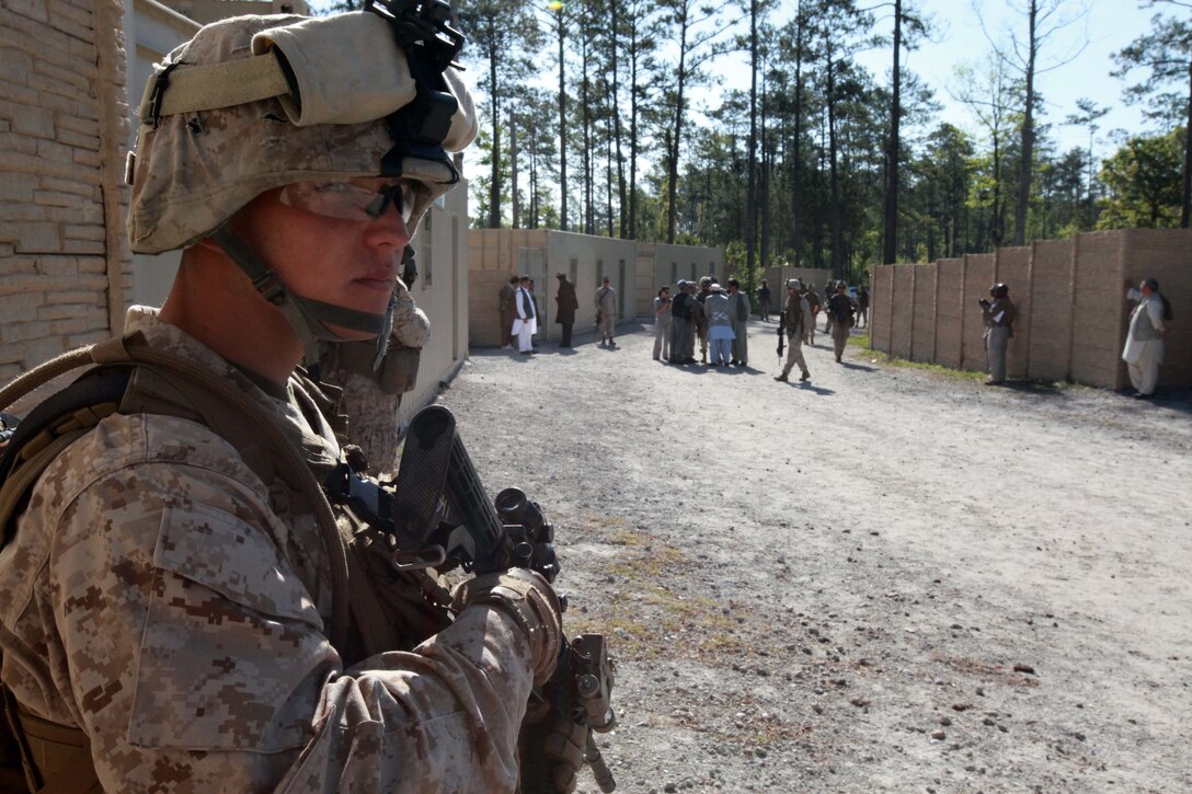 Lance Cpl. Dallin W. Jaramillo, a radio operator, with 1st Squad, 2nd Platoon, Lima Company, 3rd Battalion, 9th Marine Regiment,  2nd Marine Division, posts security during an exercise with role-playing Afghans April 16. Jaramillo a Denver, Colo., native is practicing key leader engagements and patrolling to help prepare for an upcoming deployment to Afghanistan. After the deployment Jaramillo plans to try out for the, semi-pro, Camp Lejeune Bulldogs, the installation’s football team. The Bulldogs are part of the Ultimate American Football League and made it to the play-offs in 2011. (Official U.S. Marine Corps photo by Cpl. Walter D. Marino II)::r::::n::::r::::n::