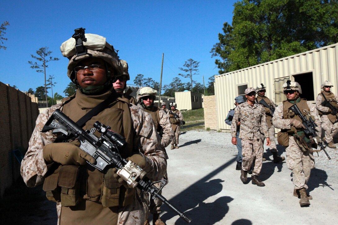 Seaman Marzell A. Scott, a hospital corpsman and (right) Corporal Mathew P. Zabik, the squad leader for 1st Squad, 2nd Platoon, Lima Company, 3rd Battalion, 9th Marine Regiment, 2nd Marine Division, patrol back to their start point after finishing a key leader engagement exercise April 16. Zabik, a Chicopee, Mass., native, and Scott, a Temple, Texas native, is practicing his patrolling skills with the battalion for an upcoming deployment to Afghanistan.