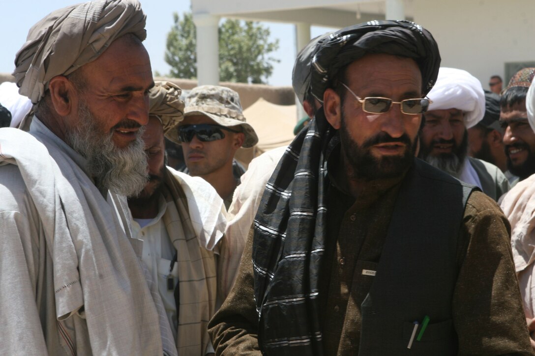Haji Zahir, the regional district governor of Marjah speaks with a city elder at a shura held at the government center in Marjah Afghanistan, June 6. The elder shura marked the third since Afghan and coalition forces arrived in the city and marked a key step to holding routine meetings.