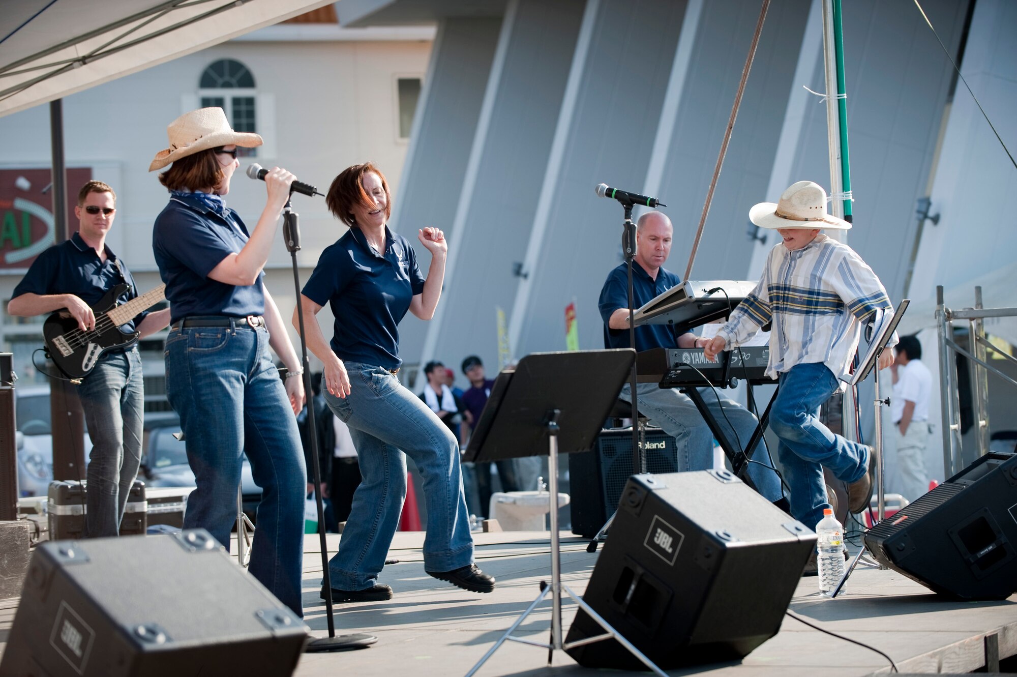 MISAWA CITY, Japan -- Staff Sgt. Rebecca Packard, Pacific Trends vocalist, dances with Daniel Ross Jr. on stage during a Pacific Trends performance at American Park during American Day, June 6. Pacific Trends performed first and last at American Park, book-ending the event that drew an estimated 80,000 visitors to downtown Misawa. (U.S. Air Force photo/Staff Sgt. Samuel Morse)
