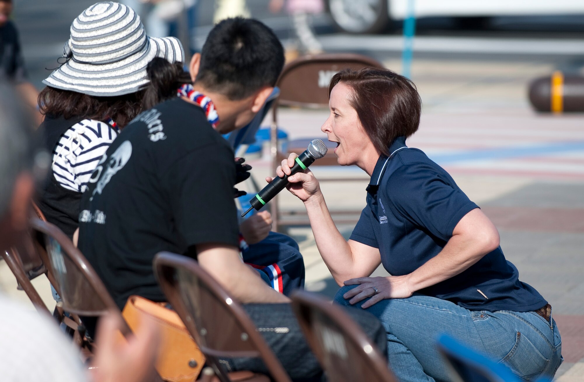 MISAWA CITY, Japan -- Staff Sgt. Rebecca Packard, Pacific Trends vocalist, sings to an audience member at American Park during American Day, June 6. Pacific Trends performed a variety of music centered around country and southern rock to keep with the American Day theme of "Wild Wild West." (U.S. Air Force photo/Staff Sgt. Samuel Morse)