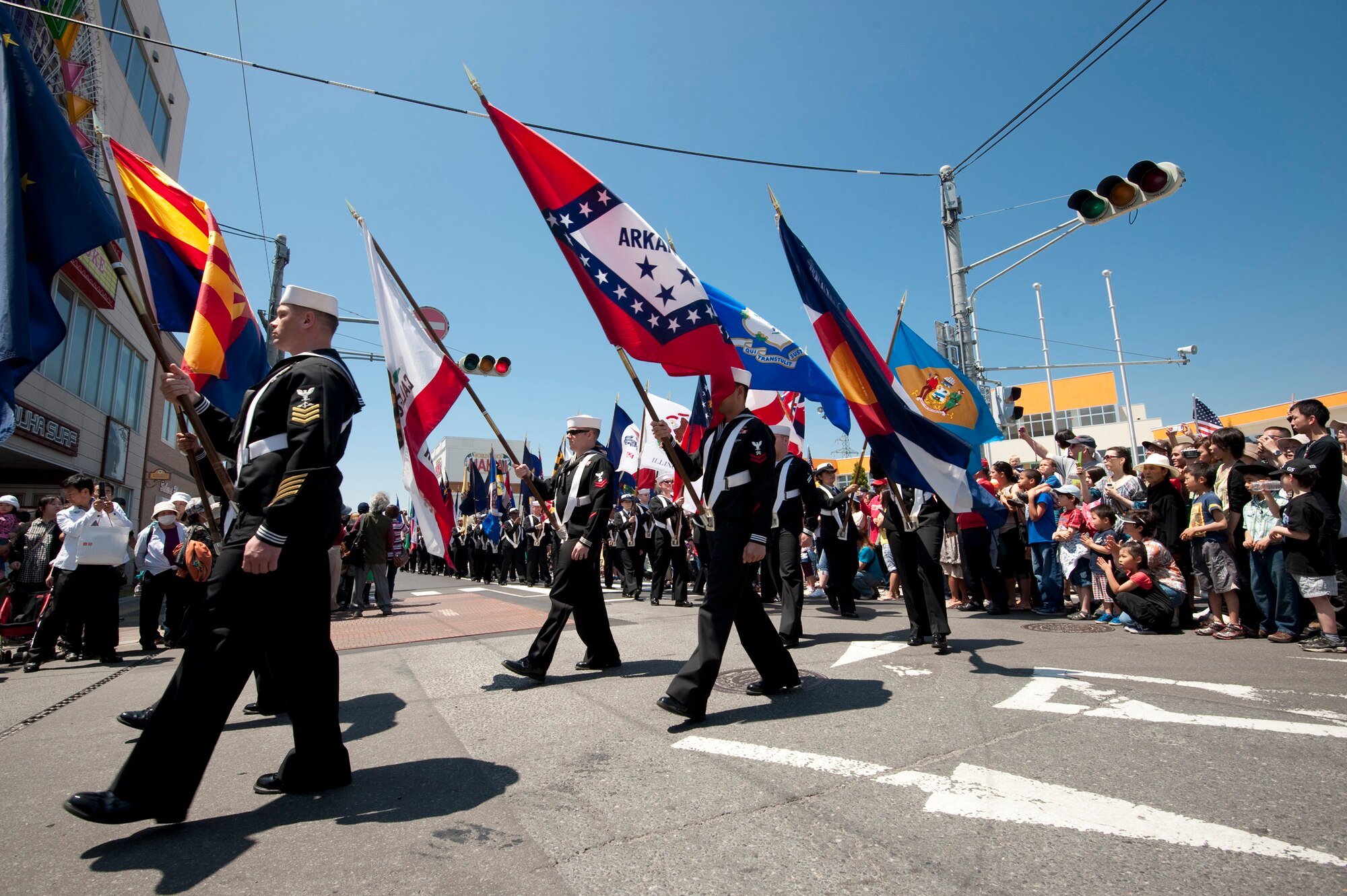 MISAWA CITY, Japan -- U.S. Navy Sailors carry the fifty state flags in the American Day Parade June 6. The Navy formation was preceded by the Misawa Air Base honor guard and Junior ROTC, leading the parade with the Japanese and American Flags. (U.S. Air Force photo/Staff Sgt. Samuel Morse)