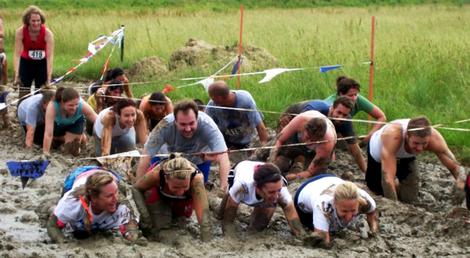 More than 1,000 runners navigated through 18 obstacles along a 3.2 mile course of muck, mud and hay during the 2nd Annual USO Mud Run at Mid-America Airport June 5, 2010. The 375th Civil Engineer Squadron helped construct the course and ensured its "mudworthiness" and numerous base volunteers assisted with the event. (Courtesy Photo)

