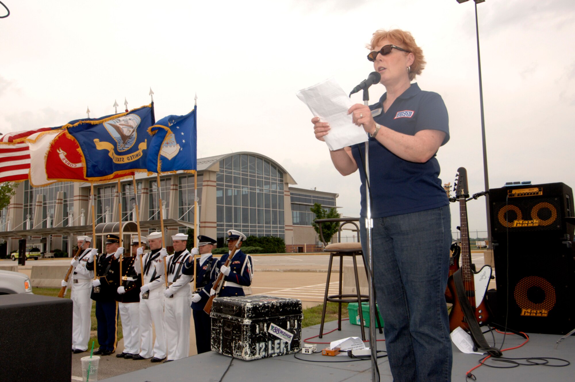 Kathy O'Connor, executive director of the USO of Missouri Inc., provides a historical intro before launching the 2nd Annual USO Mud Run at Mid-America Airport June 5, 2010, located next toScott Air Force Base, Ill. More than 1,000 runners competed in the 3.2. mile course that took them through mud, muck and hay.  Members of Scott's 375th Civil Engineering Squadron helped construct the course and ensured its "mudworthiness" and numerous base volunteers assisted with the event. (Photo by Karen Petitt/375th AMW/PA)