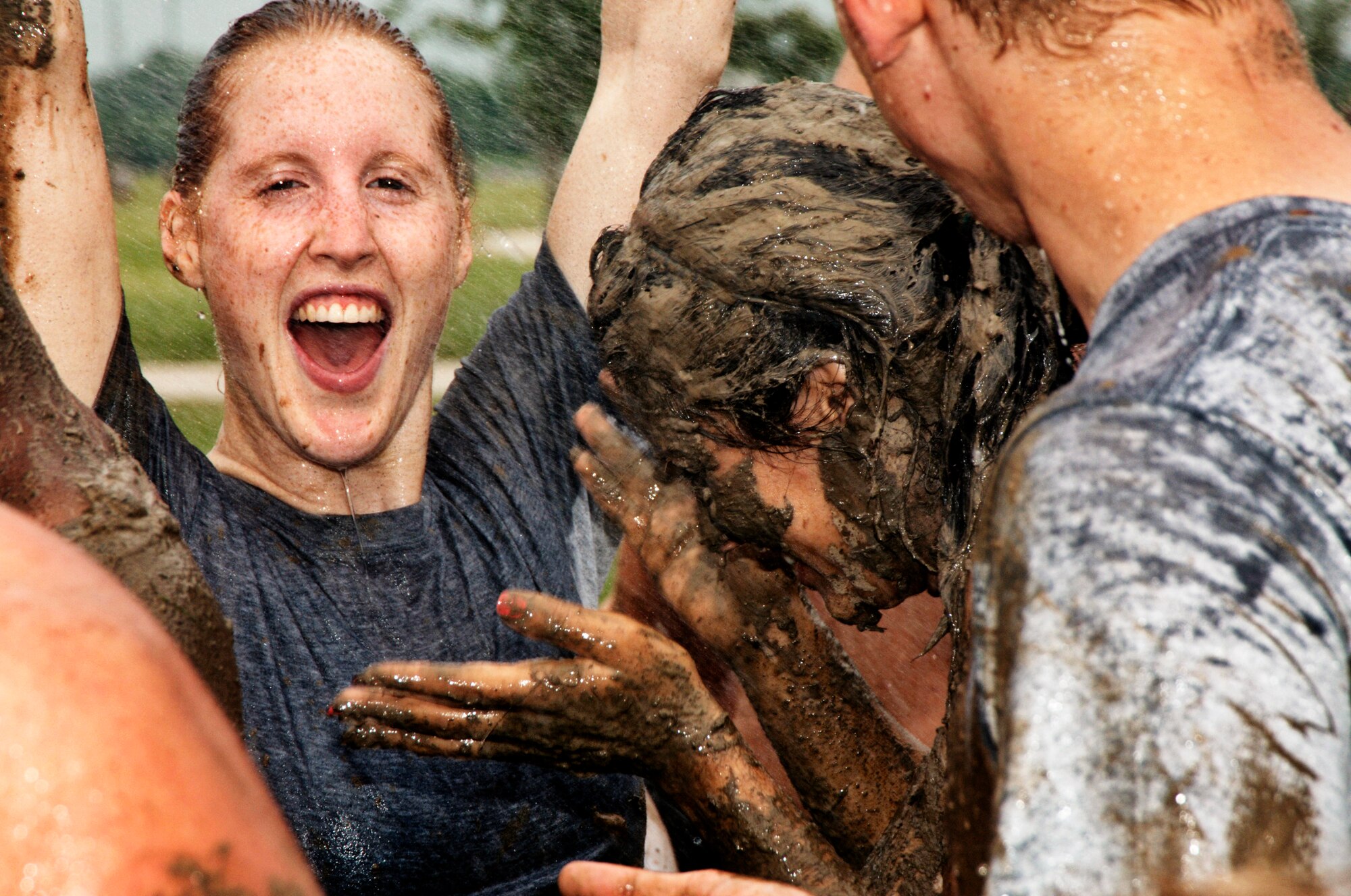 Runners wash off after running a 3.2 mile course through muck, mud and hay.  More than 1,000 runners competed in the second annual USO Mud Run at Mid-America Airport June 5, 2010. Members of Scott's 375th Civil Engineering Squadron helped construct the course and ensured its "mudworthiness" and numerous base volunteers assisted with the event. (Photo by Karen Petitt/375th AMW/PA)