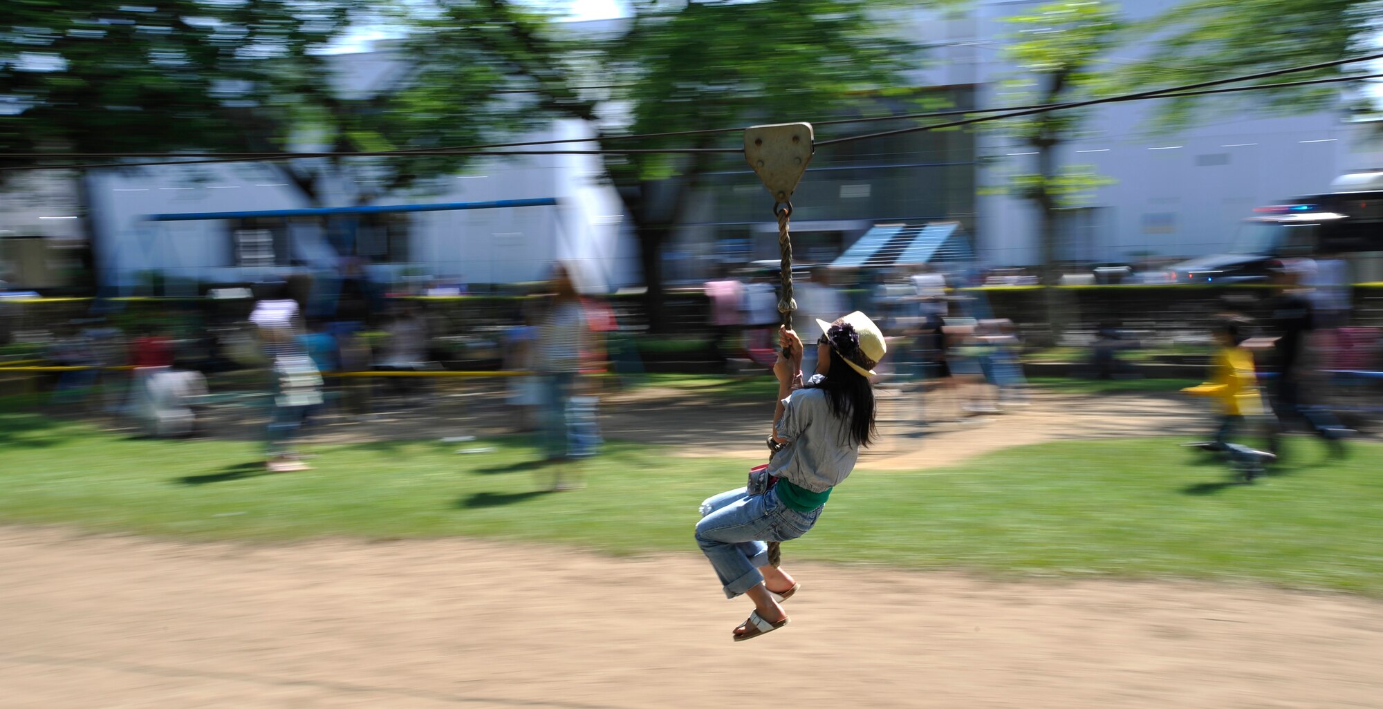 MISAWA AIR BASE, Japan -- A Japanese girl slides on a rope swing in Chuo Park during American Day June 6. Chuo Park was the site of several events such as, train rides, jumping jamboree and volleyball. (U.S. Air Force photo/Staff Sgt. Chad C. Strohmeyer)